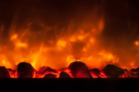 Close-up view of glowing hot coals in the electric fireplace at Happy Head Massage in San Diego, enhancing the warm and cozy ambiance of the spa.