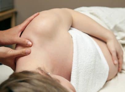 aPrenatal massage therapist working on pregnant woman at Happy Head Massage San Diego