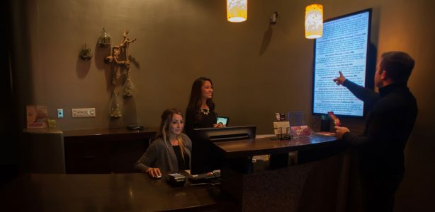 Happy Head Massage front desk staff assisting a customer with booking services, reflecting the spa's commitment to excellent customer service in San Diego.