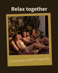 Three friends relaxing together on lounge chairs at golden hour — what to expect at a group massage