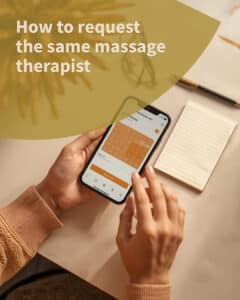 Hands using a phone calendar to request the same massage therapist for the next appointment