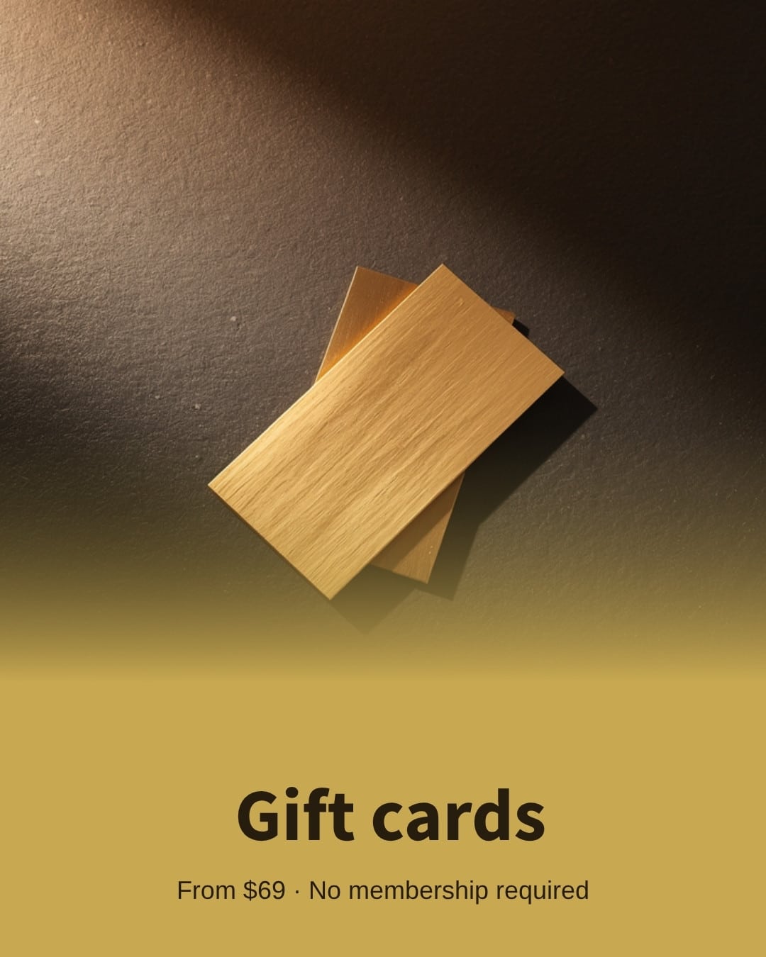 Two brushed gold gift cards on dark slate — Happy Head Massage gift cards