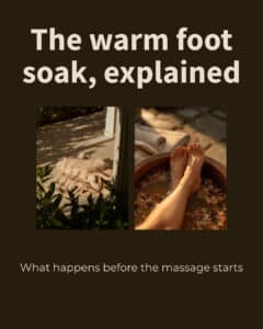Feet resting in a wooden basin of warm water for a foot soak massage