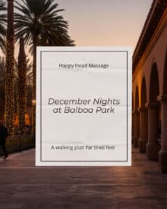 December Nights at Balboa Park: palm trees wrapped in string lights along a lit arcade at dusk